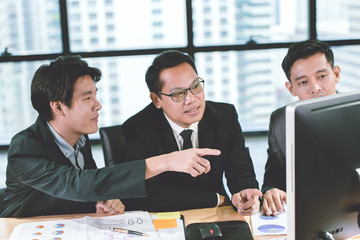 business friends men office working together help to select item in desktop computer