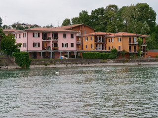 Fototapeta na wymiar Sarnico, ITALY - August 7, 2019: Lake ISEO. Beautiful houses on a city street