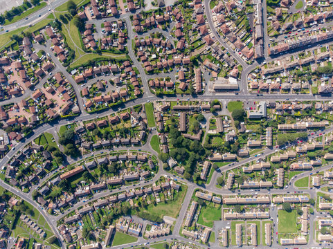 Aerial photo of the British town of Middleton in Leeds West Yorkshire showing typical suburban housing estates with rows of houses, taken on a bright sunny day using a drone.
