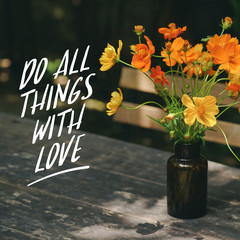 Motivational quote DO THINGS WITH LOVE. On beautiful flowers in a brown glass bottle background.