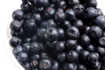 Blueberries in a glass on a white background