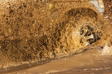 SUV wheel stalled in mud and water