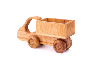 Photo of a wooden car  of beech. Toy made of wood retro truck on a white isolated background. A toy for entertaining children and resting parents