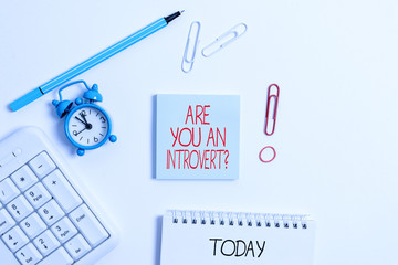 Writing note showing Are You An Introvertquestion. Business concept for demonstrating who tends to...