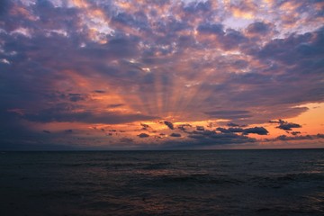 sunlight passing through the clouds in the morning on the beach