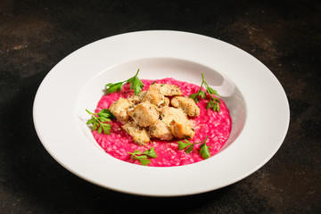 risotto chicken meat (red rice with beetroot flavor) menu concept. food background. copy space. Top view