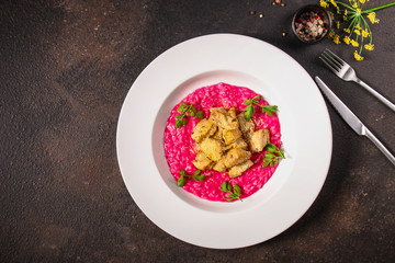risotto chicken meat (red rice with beetroot flavor) menu concept. food background. copy space. Top view