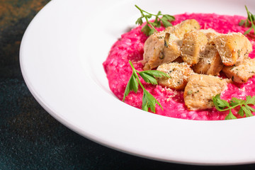 risotto chicken meat (red rice with beetroot flavor) menu concept. food background. copy space. Top view