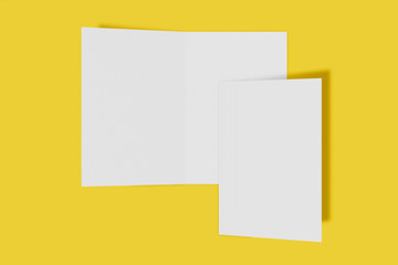 Two Mockup vertical booklet, brochure, invitation isolated on a yellow background with hard cover and realistic shadow. 3D rendering.
