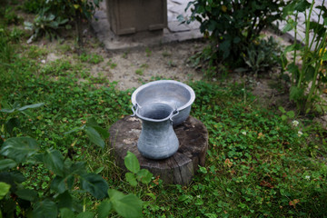 Obraz premium Ancient copper items on the stump in the garden 