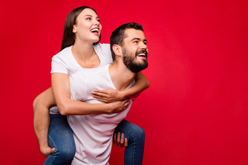 Portrait of his he her she nice attractive lovely charming cute affectionate cheerful cheery dreamy married spouses having fun isolated over bright vivid shine red background