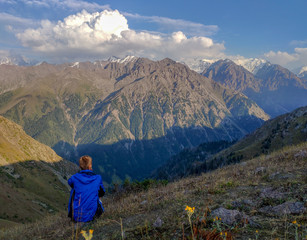 Trans-Ili Alatau mountain range of the Tien Shan system in Kazakhstan near the city of Almaty. Rocky peaks covered with snow and glaciers in the middle of summer under clouds