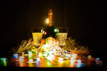 two glasses of champagne toasting against