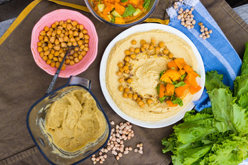Original homemade arabic chickpea hummus with olive oil and cumin. Creamy dip paste.