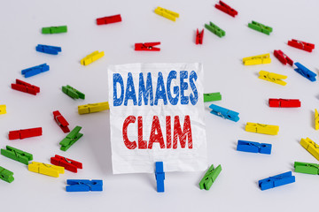 Text sign showing Damages Claim. Business photo showcasing Deanalysisd Compensation Litigate Insurance File Suit Colored clothespin papers empty reminder white floor background office