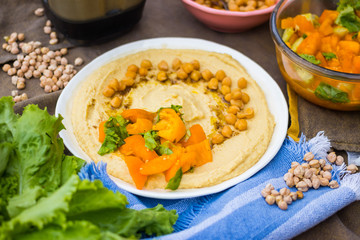Original homemade arabic chickpea hummus with olive oil and cumin. Creamy dip paste.