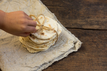 Harissa male hand pita bread rustic wooden table