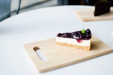 Blueberry cheese cake on wood plate