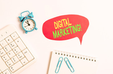 Word writing text Digital Marketing. Business photo showcasing market products or services using technologies on Internet Blank paper with copy space on the table with clock and pc keyboard