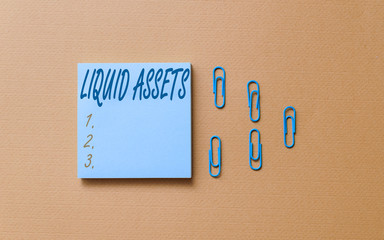 Writing note showing Liquid Assets. Business concept for Cash and Bank Balances Market Liquidity Deferred Stock Colored blank sticky note clips gathered trendy cool pastel background