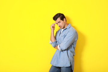 Stylish fashionable man on color background