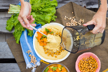 Original homemade arabic chickpea hummus with olive oil and cumin. Creamy dip paste.