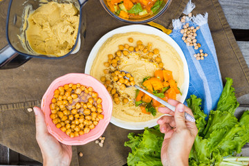 Original homemade arabic chickpea hummus with olive oil and cumin. Creamy dip paste.