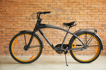 Fototapeta na wymiar Modern bicycle near brick wall