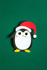 Christmas penguin on a green background large