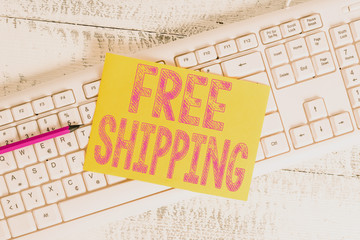 Text sign showing Free Shipping. Business photo showcasing Freight Cargo Consignment Lading Payload Dispatch Cartage White keyboard office supplies empty rectangle shaped paper reminder wood