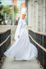 Fototapeta premium beautiful young woman in traditional islamic white dress