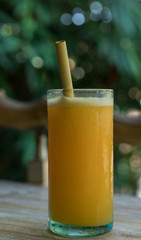 Zero waste concept with reuse bomboo straw, tropical delicious juice, Thai Bali seasonal, cool ice beverage for refreshing in summer on green nature bokeh background