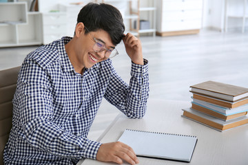 Asian student preparing for exam at home