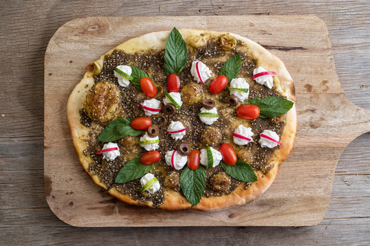 lebanese Manoushe ,bread of thyme topped with mint, reddish, and Labneh; Lebanese Zaatar Manouche; zaatar flat bread