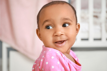 Portrait of cute African-American baby at home