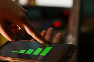 hands showing profit graph on a smart phone