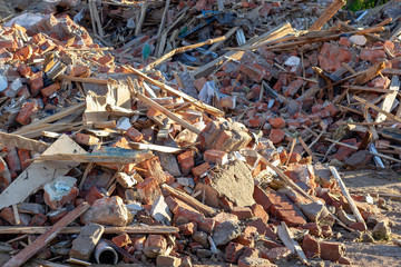 Сonstruction garbage, debris and waste rubble in a remote green area. Nature and soil pollution concept