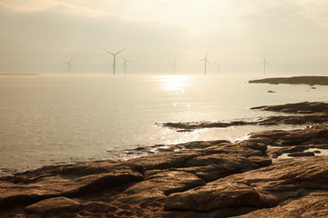 Wind mill power generator farm for renewable energy production along coast of Bothnian Sea near Pori, Finland. Alternative green clean energy, ecology.