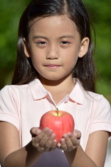 Serious Filipina Person With An Apple