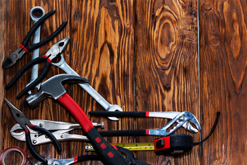 Close up tools on a wooden background.