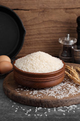 Obraz na płótnie Canvas thai white jasmine rice in wooden bowl in kitchen with a blank space for a text, thai agriculture concept