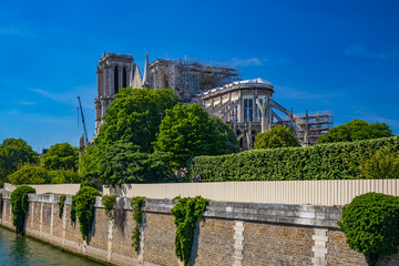 Fototapeta premium Notre Dame de Paris reconstruction, scaffoldings and work in progress after the fire destroyed the cathedral on 15 April 2019