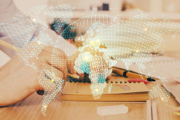 Double exposure of hands and notepad with business icons.