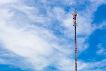 Cell phone tower with blue sky background on a sunny day.