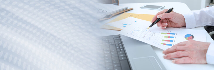 Businesswoman working on financial graphs; panoramic banner