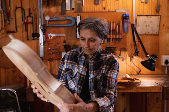 Female luthier at work in a workshop