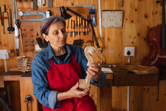 Female luthier at work in a workshop