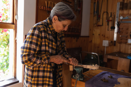 Female luthier at work in a workshop