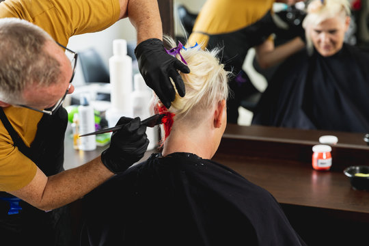 Male hairdresser and female client in hair salon