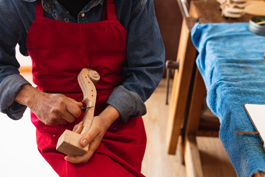 Female luthier at work in a workshop